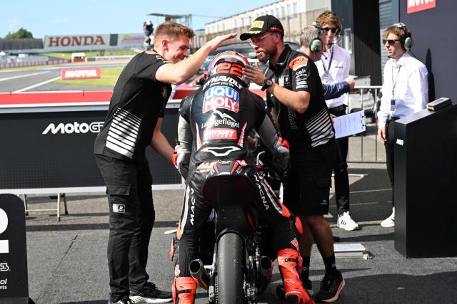 Liqui Moly Dynavolt Intract GP rider David Almansa of Spain is celebrated his pole position by team officers at the Parc Ferme of the Moto3 class qualifying session of MotoGP Japanese Grand Prix at the Mobility Resort Motegi in Motegi, Tochigi prefecture on October 3, 2026. (Photo by Toshifumi KITAMURA / AFP)