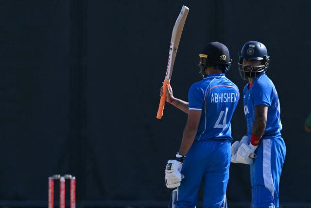 India's Abhishek Sharma (L) celebrates a half century during the men's cricket final match between Pakistan and India during the 2026 Asian Games at the Korogi Athletic Park in Nisshin on October 3, 2026. (Photo by ANDREW CABALLERO-REYNOLDS / AFP)