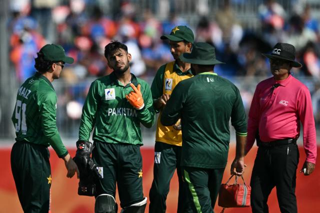 Pakistan's wicketkeeper Usman Khan (2nd L) reacts after getting hit with the ball during the men's cricket final match between Pakistan and India during the 2026 Asian Games at the Korogi Athletic Park in Nisshin on October 3, 2026. (Photo by ANDREW CABALLERO-REYNOLDS / AFP)
