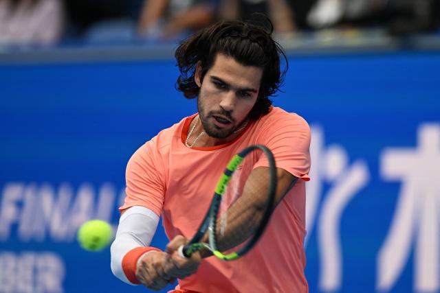 Spain's Carlos Alcaraz hits a return against Italy's Matteo Arnaldi during their men's singles tennis match at the ATP Tour Japan Open Tennis Championships at the Ariake Tennis Forest Park in Tokyo on October 3, 2026. (Photo by Rie KIKUCHI / AFP)