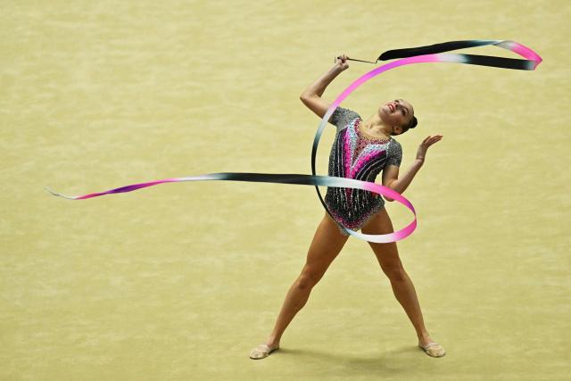 Kyrgyzstan's Zlata Olegovna Arkatova competes in the individual ribbon for the rhythmic gymnastics finals during the 2026 Asian Games at the Nagoya General Gymnasium in Nagoya on October 3, 2026. (Photo by MOHD RASFAN / AFP)