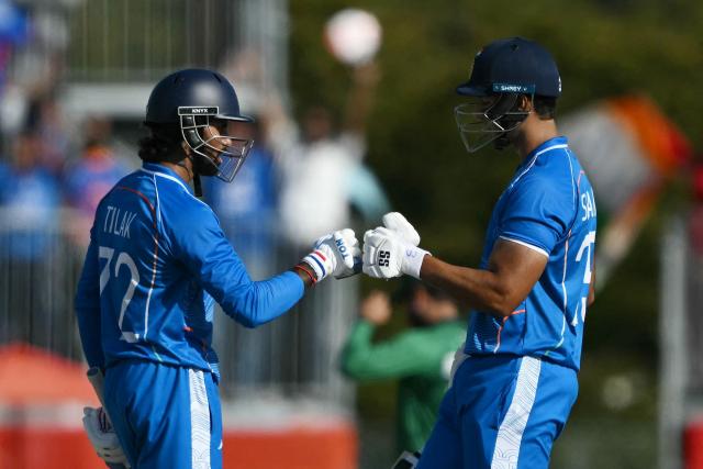 India's Tilak Varma (L) celebrates his six with  teammate Shivam Dube during the men's cricket final match between Pakistan and India during the 2026 Asian Games at the Korogi Athletic Park in Nisshin on October 3, 2026. (Photo by ANDREW CABALLERO-REYNOLDS / AFP)