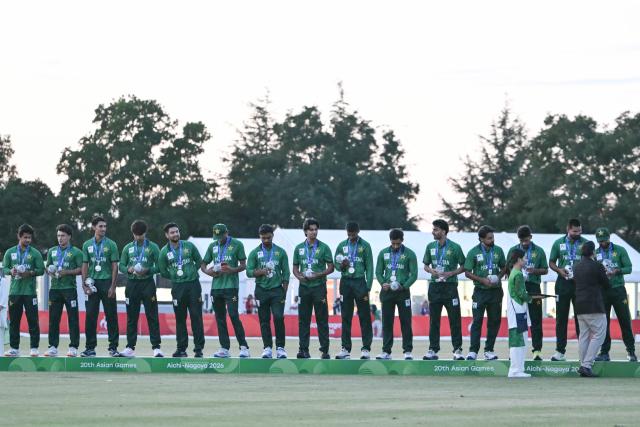 Silver medallists Pakistan stand on the podium during the victory ceremony for the men's cricket in the 2026 Asian Games at the Korogi Athletic Park in Nisshin on October 3, 2026. (Photo by ANDREW CABALLERO-REYNOLDS / AFP)