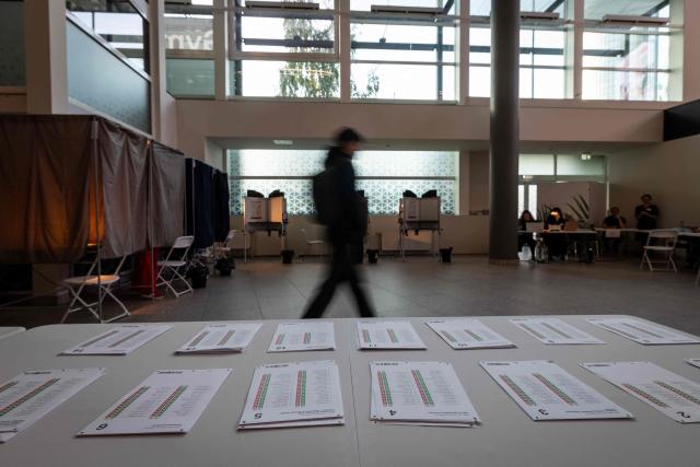 A voter arrives at a polling station to cast a ballot during Latvia's parliamentary elections in Riga on October 3, 2026. (Photo by Wojtek RADWANSKI / AFP)