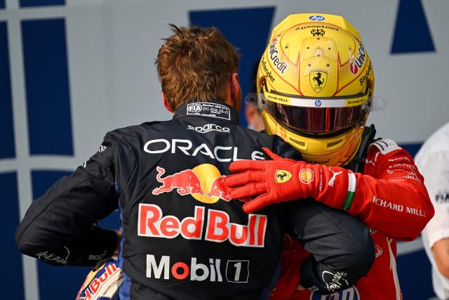Red Bull Racing's Dutch driver Max Verstappen (L) hugs Ferrari's British driver Lewis Hamilton after the qualifying session of the Formula One Bahrain Grand Prix in Sepang on October 3, 2026. (Photo by Jade Gao / AFP)