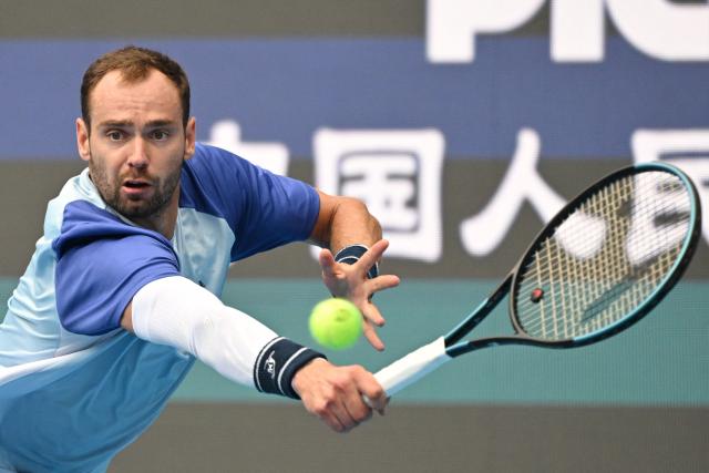 Russia’s Roman Safiullin hits a return to compatriot Andrey Rublev in their men’s singles match at the China Open tennis tournament in Beijing on October 3, 2026. (Photo by GREG BAKER / AFP)