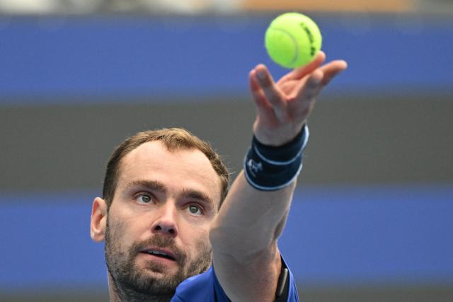 Russia’s Roman Safiullin serves to compatriot Andrey Rublev in their men’s singles match at the China Open tennis tournament in Beijing on October 3, 2026. (Photo by GREG BAKER / AFP)