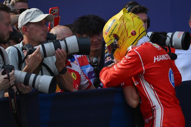 Ferrari's British driver Lewis Hamilton hugs a team member after qualifying in second position following the qualifying session of the Formula One Bahrain Grand Prix in Sepang on October 3, 2026. (Photo by Jade Gao / AFP)