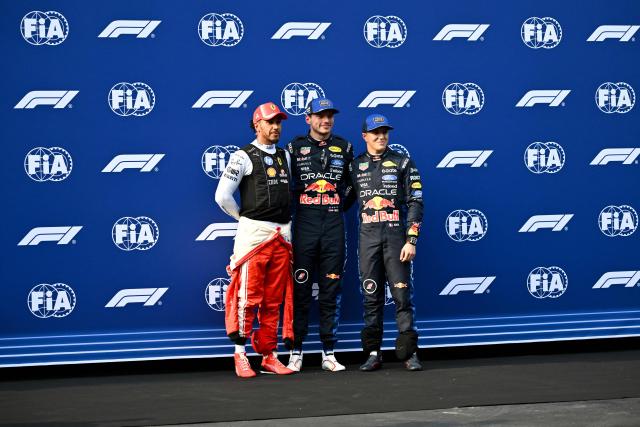 Red Bull Racing's Dutch driver Max Verstappen (C), who qualified in pole position, poses with second-position Ferrari's British driver Lewis Hamilton (L) and third-position Red Bull Racing's French driver Isack Hadjar after the qualifying session of the Formula One Bahrain Grand Prix in Sepang on October 3, 2026. (Photo by Jade Gao / AFP)