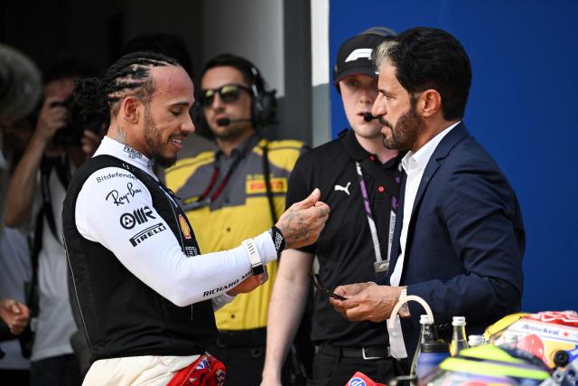 Ferrari's British driver Lewis Hamilton (L) speaks to President of the FIA Mohammed Ben Sulayem (R) following the qualifying session of the Formula One Bahrain Grand Prix in Sepang on October 3, 2026. (Photo by Jade Gao / AFP)