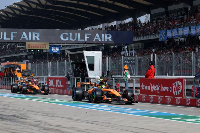 McLaren's British driver Lando Norris (R) and McLaren's Australian driver Oscar Piastri drive during the qualifying session of the Formula One Bahrain Grand Prix in Sepang on October 3, 2026. (Photo by Annice Lyn / POOL / AFP)