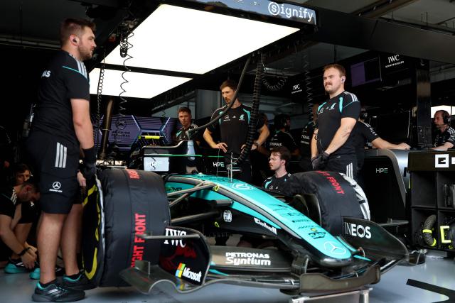 The crew of Mercedes' Italian driver Kimi Antonelli stand around the car before the qualifying session of the Formula One Bahrain Grand Prix in Sepang on October 3, 2026. (Photo by Annice Lyn / POOL / AFP)