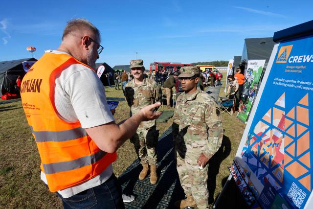 Exercise participants and volunteers take part in the "Vytis Skliautas 2026" civil protection exercise at a humanitarian training camp at the Lazdijai Hippodrome in Lazdijai, Lithuania on October 3, 2026, as the drill tests the country's readiness for mobilization. (Photo by Petras Malukas / AFP)