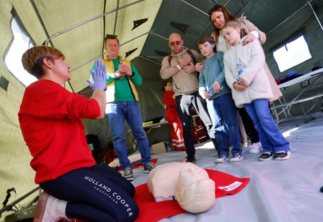 Exercise participants and volunteers take part in the "Vytis Skliautas 2026" civil protection exercise at a humanitarian training camp at the Lazdijai Hippodrome in Lazdijai, Lithuania on October 3, 2026, as the drill tests the country's readiness for mobilization. (Photo by Petras Malukas / AFP)