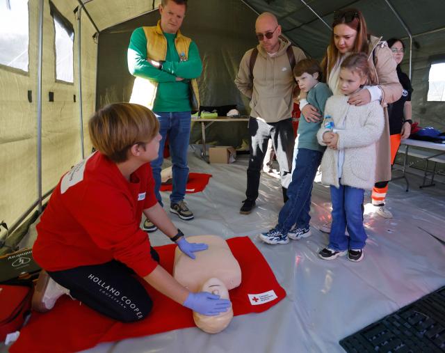 Exercise participants and volunteers take part in the "Vytis Skliautas 2026" civil protection exercise at a humanitarian training camp at the Lazdijai Hippodrome in Lazdijai, Lithuania on October 3, 2026, as the drill tests the country's readiness for mobilization. (Photo by Petras Malukas / AFP)