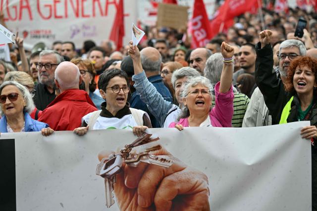 Demonstrators hold a banner reading 'General strike' during a protest against evictions and high rent prices on Plaza de Espana on October 3, 2026. Protests over housing are take place across Spain, a day after parliament rejected two government measures to strengthen protection for tenants. (Photo by JAVIER SORIANO / AFP)