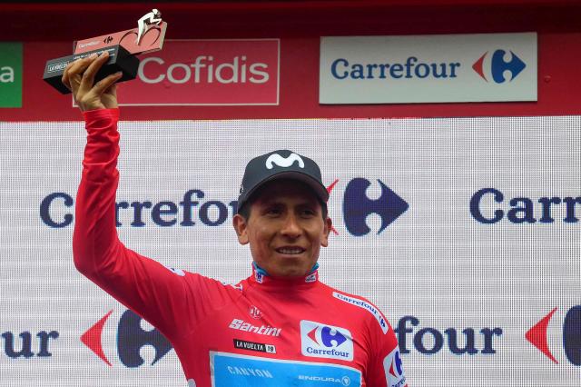 (FILES) Team Movistar rider Colombia's Nairo Quintana, wearing the leader´s red jersey, celebrates on the podium after  the ninth stage of the 2019 La Vuelta cycling tour of Spain, a 94,4 km race from Andorra la Vella to Cortals d'Encamp on September 1, 2019 in Els Cortals. Quintana, the son of a farming family in the Andes, turned into a daring beetle who shook Colombia to its core, fighting epic battles that made him a legend. (Photo by JOSE JORDAN / AFP)