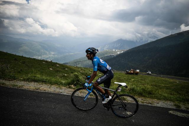 (FILES) Colombia's Nairo Quintana rides up the Col du Portet pass on his way to win the 17th stage of the 105th edition of the Tour de France cycling race, between Bagneres-de-Luchon and Saint-Lary-Soulan Col du Portet, southwestern France, on July 25, 2018. Quintana, the son of a farming family in the Andes, turned into a daring beetle who shook Colombia to its core, fighting epic battles that made him a legend. (Photo by Jeff PACHOUD / AFP)