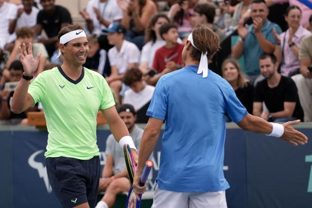 Spanish player Rafael Nadal (L) slaps hands with Spain's David Ferrer during a tennis match marking Rafa Nadal Academy's 10th anniversary, in Manacor on the Spanish Balearic Island of Mallorca on October 3, 2026. Two years after retiring, Spanish superstar Rafael Nadal returns on court to mark the 10th anniversary of his academy in Mallorca. (Photo by Manaure QUINTERO / AFP)