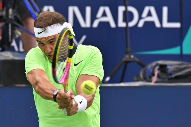 Spanish player Rafael Nadal returns the ball during a tennis match marking Rafael Nadal academy's 10th anniversary, in Manacor on the Spanish Balearic Island of Mallorca on October 3, 2026. Two years after retiring, Spanish superstar Rafael Nadal returns on court to mark the 10th anniversary of his academy in Mallorca. (Photo by Manaure QUINTERO / AFP)