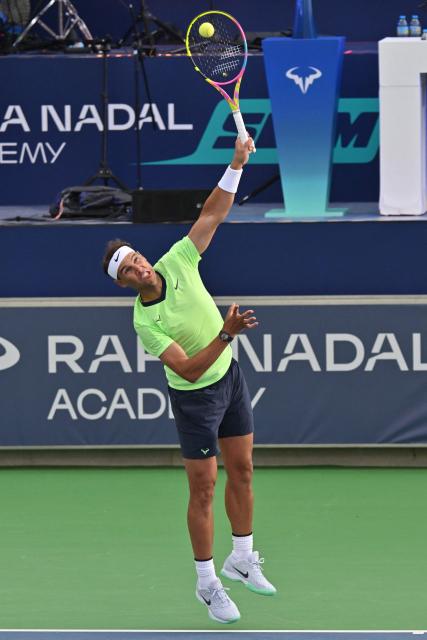 Spanish player Rafael Nadal serves the ball during a tennis match marking Rafa Nadal Academy's 10th anniversary, in Manacor on the Spanish Balearic Island of Mallorca on October 3, 2026. Two years after retiring, Spanish superstar Rafael Nadal returns on court to mark the 10th anniversary of his academy in Mallorca. (Photo by Manaure QUINTERO / AFP)