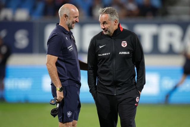 Castres' head coach Xavier Sadourny (L) speaks with Toulouse's French head coach Ugo Mola (R) before the French Top14 rugby union match between Castres Olympique and Stade Toulousain at Stade Pierre Fabre in Castres, southwestern France, on October 3, 2026. (Photo by Valentine CHAPUIS / AFP)