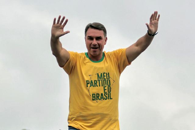 Brazil's right-wing senator and presidential candidate Flavio Bolsonaro of the Liberal Party (PL) waves during a campaign rally on the eve of the general election, in Campo Grande neighborhood, in the western zone of Rio de Janeiro, Brazil on October 3, 2026. Brazilians go to the polls on October 4, 2026, in a tight race led by leftist President Luiz Inacio Lula da Silva and right-wing senator Flavio Bolsonaro, son of former president Jair Bolsonaro, who is serving house arrest. (Photo by Douglas SHINEIDR / AFP)