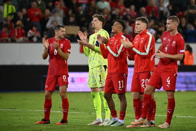(From L) Switzerland's midfielder #08 Remo Freuler, Switzerland's goalkeeper #01 Gregor Kobel, Switzerland's midfielder #11 Dan Ndoye, Switzerland's midfielder #20 Michel Aebischer and Switzerland's defender #04 Nico Elvedi react after winning the UEFA Nations League Group B1 football match between Switzerland and Slovenia at the Thermoplan Arena in Lucerne on October 3, 2026. (Photo by Fabrice COFFRINI / AFP)