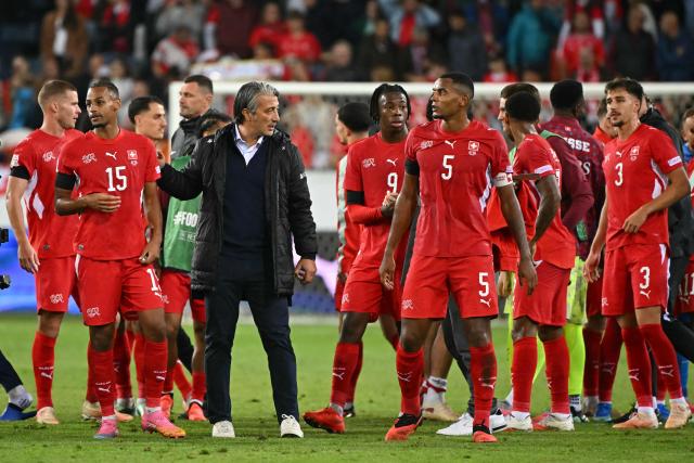 Switzerland's coach Murat Yakin reacts next to his players after Switzerland won the UEFA Nations League Group B1 football match between Switzerland and Slovenia at the Thermoplan Arena in Lucerne on October 3, 2026. (Photo by Fabrice COFFRINI / AFP)