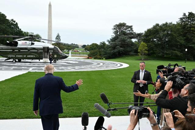 US President Donald Trump waves to the media before boarding Marine One on the South Lawn of the White House, in Washington, DC, on October 3, 2026. President Trump is travelling to Ohio for a midterm campaign rally. (Photo by Alex WROBLEWSKI / AFP)