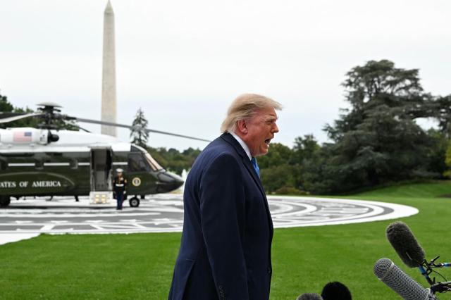 US President Donald Trump talks to the media before boarding Marine One on the South Lawn of the White House, in Washington, DC, on October 3, 2026. President Trump is travelling to Ohio for a midterm campaign rally. (Photo by Alex WROBLEWSKI / AFP)