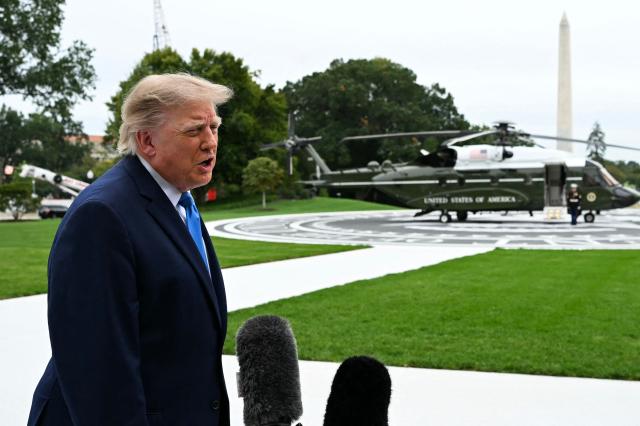 US President Donald Trump talks to the media before boarding Marine One on the South Lawn of the White House, in Washington, DC, on October 3, 2026. President Trump is travelling to Ohio for a midterm campaign rally. (Photo by Alex WROBLEWSKI / AFP)