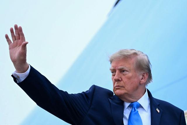US President Donald Trump waves as he boards Air Force One at Joint Base Andrews, Maryland, on October 3, 2026. President Trump is travelling to Ohio for a midterm campaign rally. (Photo by Brendan SMIALOWSKI / AFP)