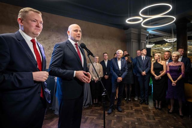 Latvia's Prime Minister Andris Kulbergs (2ndL) speaks after the first exit poll results of the parliamentary election were announced during an election night event of his centre-right Apvienotais Saraksts (United List) party in Riga on October 3, 2026. (Photo by Wojtek RADWANSKI / AFP)