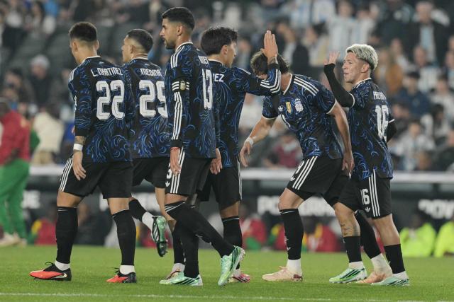 Argentina's forward #16 Gianluca Prestianni (R) celebrates scoring his team's third goal with teammates during the international friendly football match between Argentina and Burkina Faso at the Mas Monumental stadium in Buenos Aires on October 3, 2026. (Photo by JUAN MABROMATA / AFP)