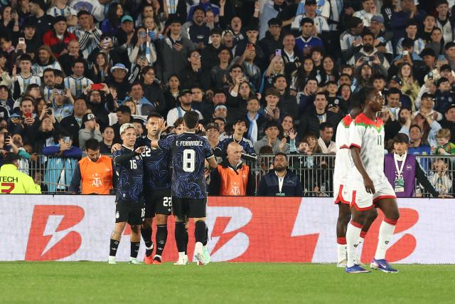 Argentina's forward #16 Gianluca Prestianni (L) celebrates scoring his team's third goal with teammates during the international friendly football match between Argentina and Burkina Faso at the Mas Monumental stadium in Buenos Aires on October 3, 2026. (Photo by Alejandro PAGNI / AFP)