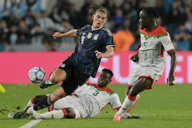 Argentina's midfielder #18 Nico Paz and Burkina Faso's defender #03 Moumouni Diallo fight for the ball during the international friendly football match between Argentina and Burkina Faso at the Mas Monumental stadium in Buenos Aires on October 3, 2026. (Photo by JUAN MABROMATA / AFP)