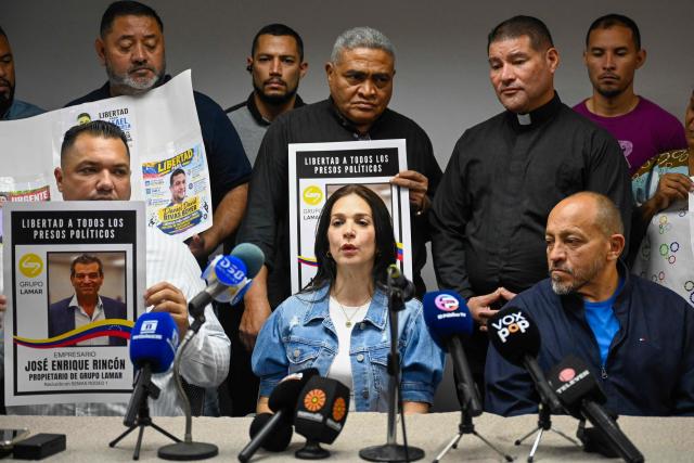 Former political prisoners Daniel Romero (L), Jose Sanchez (Mazuco) (R), and Mariana Rincon, a relative of former political prisoner Jose Enrique Rincon, attend a press conference in Maracaibo, Venezuela on October 3, 2026. After Nicolas Maduro's capture in a US operation in January, interim President Delcy Rodriguez, who governs under pressure from Washington, pushed through an amnesty that she says has led to the release of 1,046 people from prison. (Photo by Maryorin Mendez / AFP)