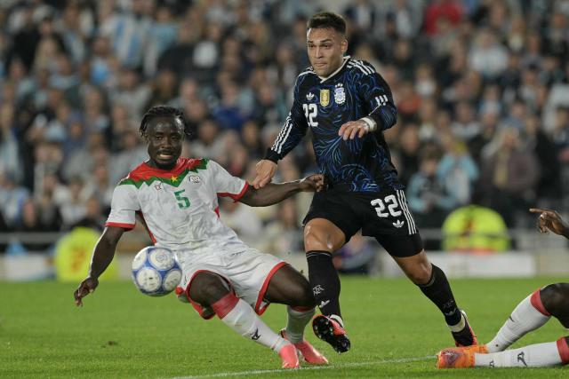 Burkina Faso's midfielder #05 Hassamadou Ouedraogo and Argentina's forward #22 Lautaro Martinez fight for the ball during the international friendly football match between Argentina and Burkina Faso at the Mas Monumental stadium in Buenos Aires on October 3, 2026. (Photo by JUAN MABROMATA / AFP)