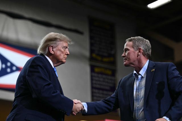 US Senator Jon Husted (R-OH) shakes hands with US President Donald Trump after he spoke in Vandalia, Ohio, on October 3, 2026. (Photo by Brendan SMIALOWSKI / AFP)