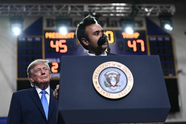 US President Donald Trump looks on as Ohio Governor candidate Vivek Ramaswamy speaks during a campaign rally in Vandalia, Ohio, on October 3, 2026. (Photo by Brendan SMIALOWSKI / AFP)