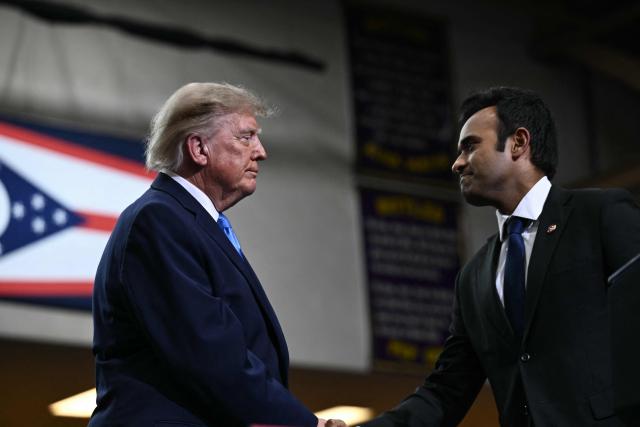 US President Donald Trump shakes hands with Ohio Governor candidate Vivek Ramaswamy after speaking during a campaign rally in Vandalia, Ohio, on October 3, 2026. (Photo by Brendan SMIALOWSKI / AFP)