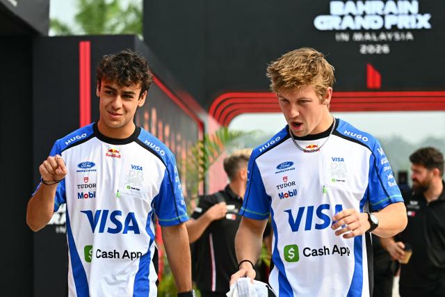 Racing Bulls' British driver Arvid Lindblad (L) talks with Racing Bulls' New Zealand driver Liam Lawson as they arrive ahead of the Formula One Bahrain Grand Prix in Sepang on October 4, 2026. (Photo by Lillian SUWANRUMPHA / AFP)