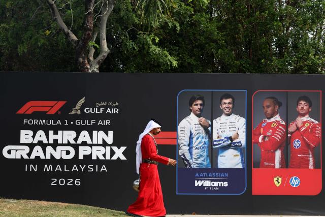 A man walks past signage for the Formula One Bahrain Grand Prix in Sepang on October 4, 2026. (Photo by I-HWA CHENG / AFP)