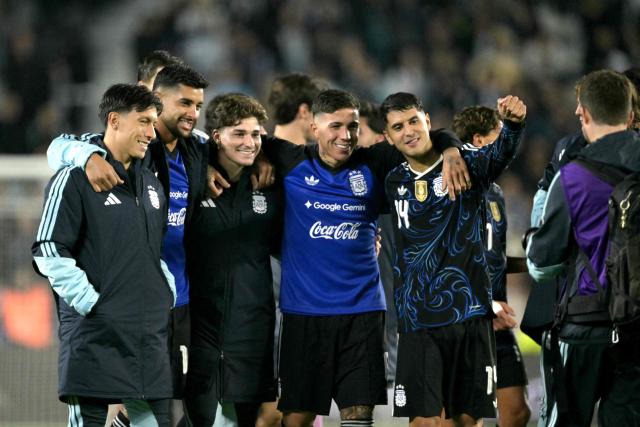 (L to R) Argentina's defender #06 Lisandro Martinez, defender #13 Cristian Romero, forward #09 Julian Alvarez, midfielder #08 Enzo Fernandez, and midfielder #14 Exequiel Palacios pose for a photo after winning the international friendly football match between Argentina and Burkina Faso at the Mas Monumental stadium in Buenos Aires on October 3, 2026. (Photo by JUAN MABROMATA / AFP)