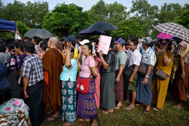 Family members queue for registration as they wait outside the Myanmar Navy base in Thanlyin on October 4, 2026 to welcome their loved ones returning from Malaysia. Nearly 1,500 Myanmar migrants from Malaysia arrived in their war-torn home country on October 4, a Myanmar official said, returned under an opaque repatriation scheme that rights monitors say cannot assure their safety. (Photo by Sai Aung MAIN / AFP)