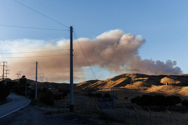 Smoke is seen rising from the Bouquet Fire as it burns in the Angeles National Forest near Santa Clarita, California on October 3, 2026. The fire, which has prompted evacuation orders in the area, come as an extended heat wave hits Southern California. (Photo by Blake Fagan / AFP)