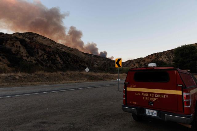 Smoke is seen rising from the Bouquet Fire as it burns in the Angeles National Forest near Santa Clarita, California on October 3, 2026. The fire, which has prompted evacuation orders in the area, come as an extended heat wave hits Southern California. (Photo by Blake Fagan / AFP)