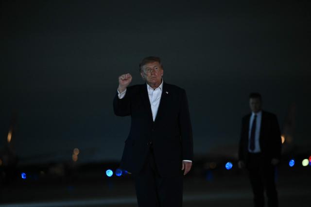 US President Donald Trump makes a fist after disembarking from Air Force One at Joint Base Andrews, Maryland, on October 3, 2026. President Trump is returning to Washington after a trip to Ohio where he spoke at a midterm campaign rally. (Photo by Brendan SMIALOWSKI / AFP)