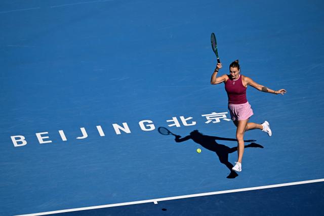 Belarus's Aryna Sabalenka hits a return to Czech Republic's Nikola Bartunkova during their women's singles match at the China Open tennis tournament in Beijing on October 4, 2026. (Photo by Pedro PARDO / AFP)